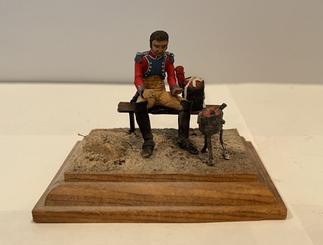 own Manufacturer. Matte finish painted figure of a Napoleonic Soldier on Bench with Camp Fire